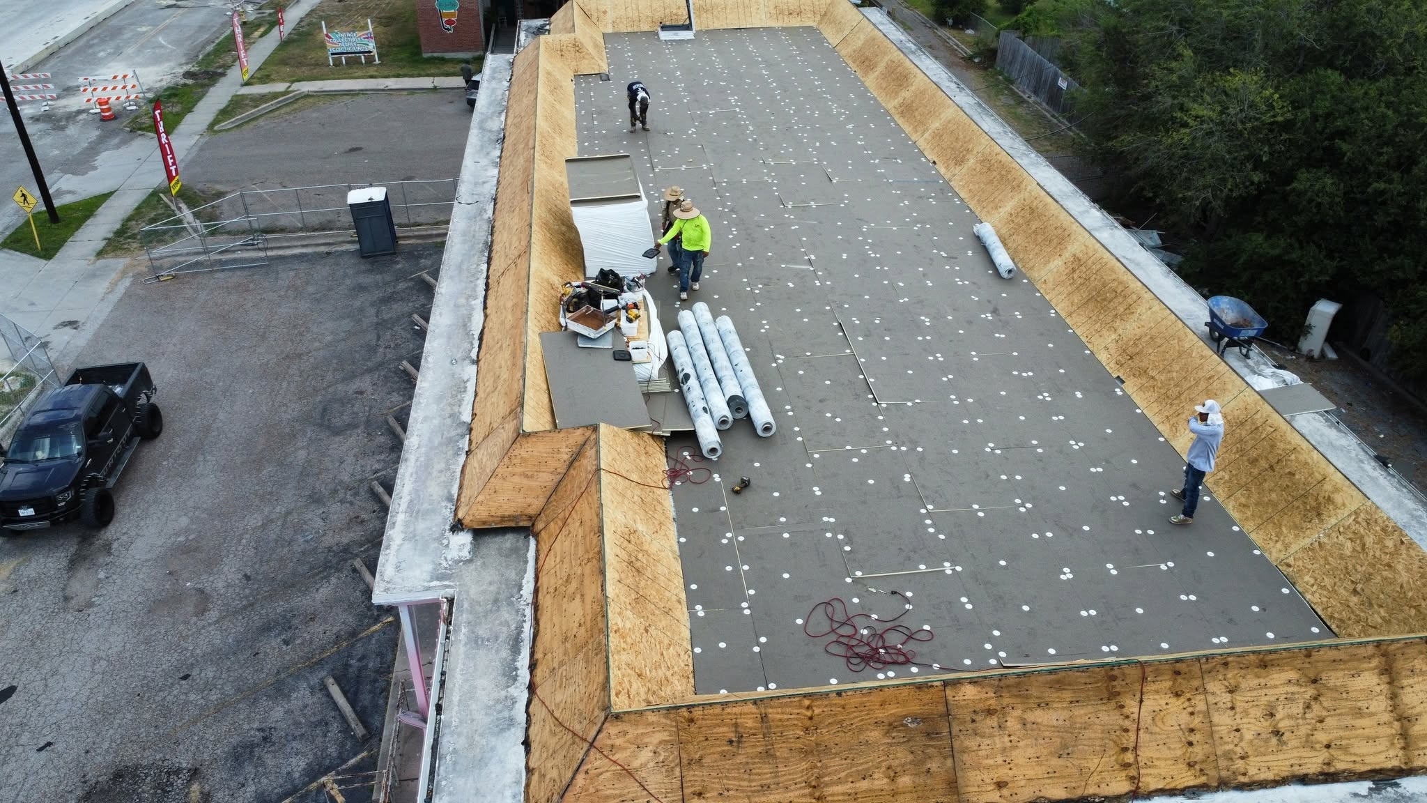 Commercial roofing installation underway by Unique Roofing
